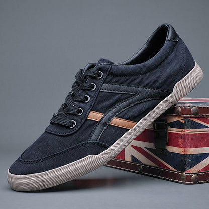 Navy blue sneaker with white sole on a gray background