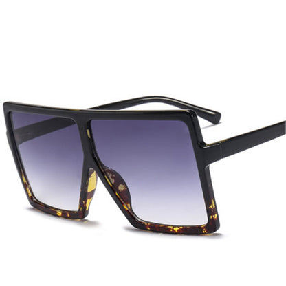 Sunglasses with black frame and gradient lenses on a white background