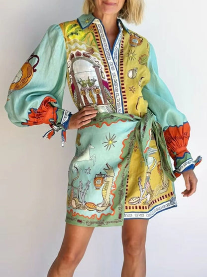 Colorful patterned dress with long sleeves and a belt on a plain background
