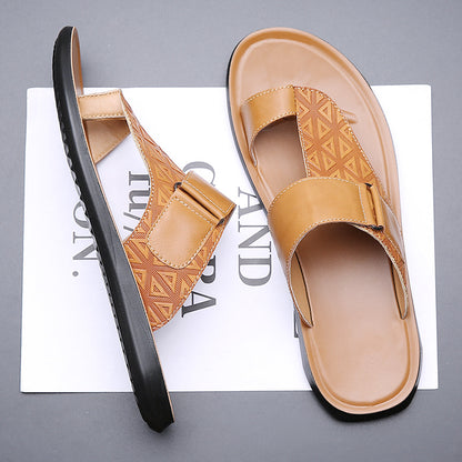 Pair of tan sandals on a magazine with a gray background
