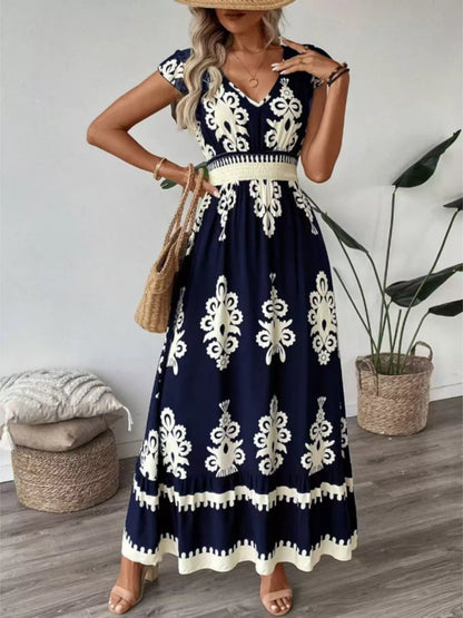 Woman wearing a navy blue dress with white patterns indoors.