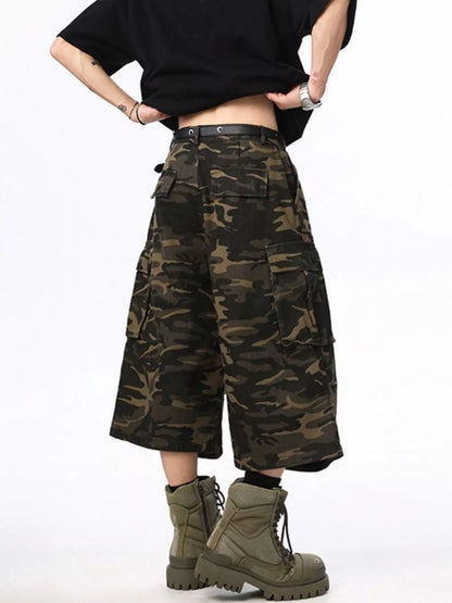 Person wearing camouflage cargo pants and green boots on a white background