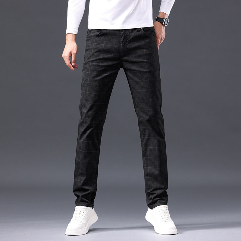 Person wearing black plaid pants on a gray background