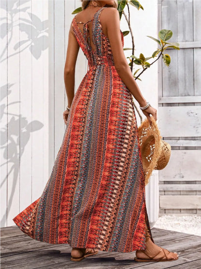 Woman wearing a colorful patterned dress with a wooden deck and plants in the background