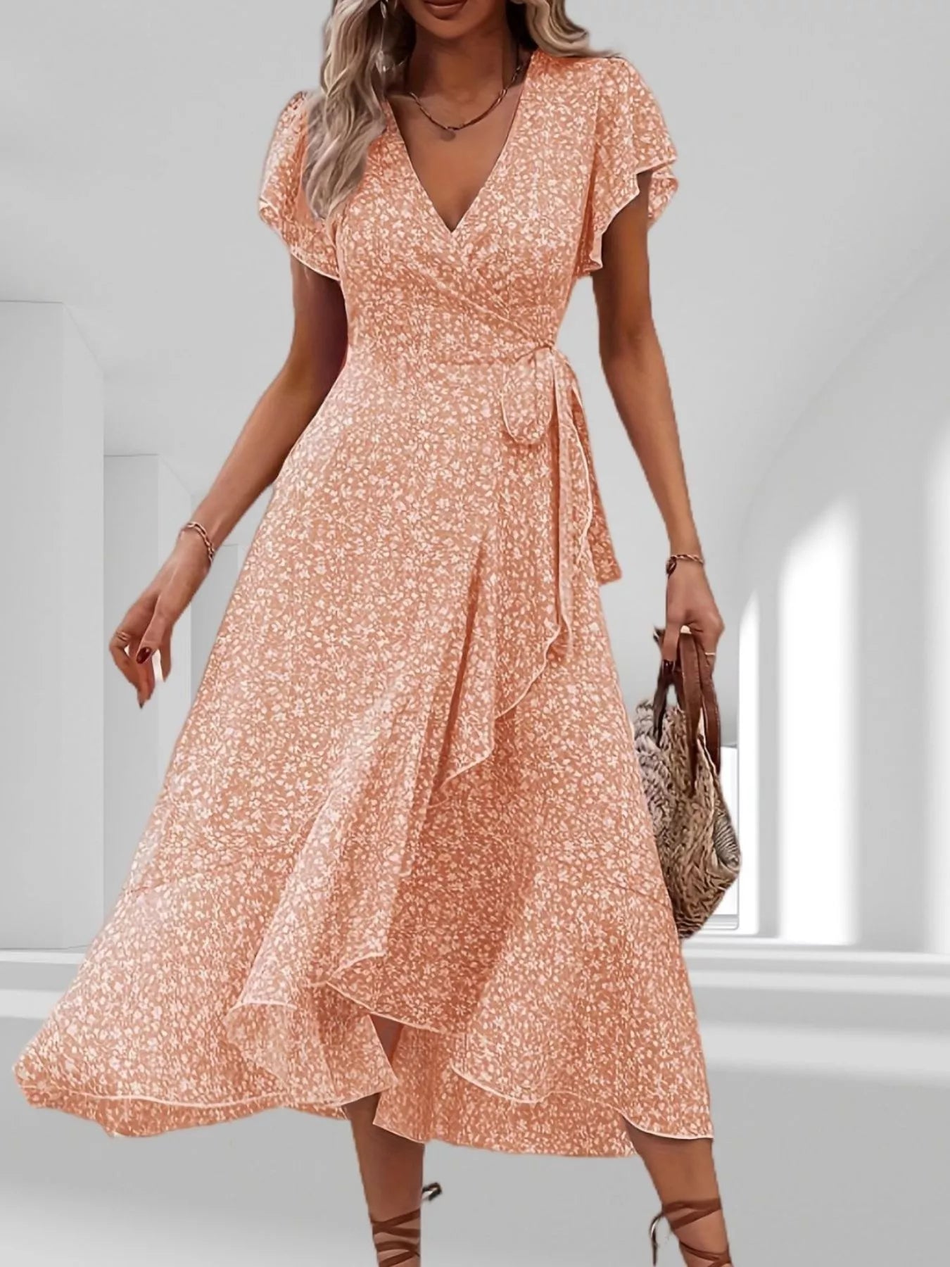 Woman wearing a floral dress in a minimal indoor setting