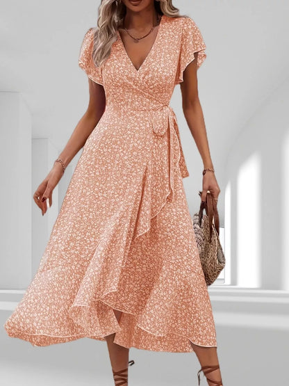 Woman wearing a floral dress in a minimal indoor setting