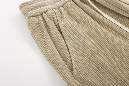 Close-up of beige ribbed pants on a white background