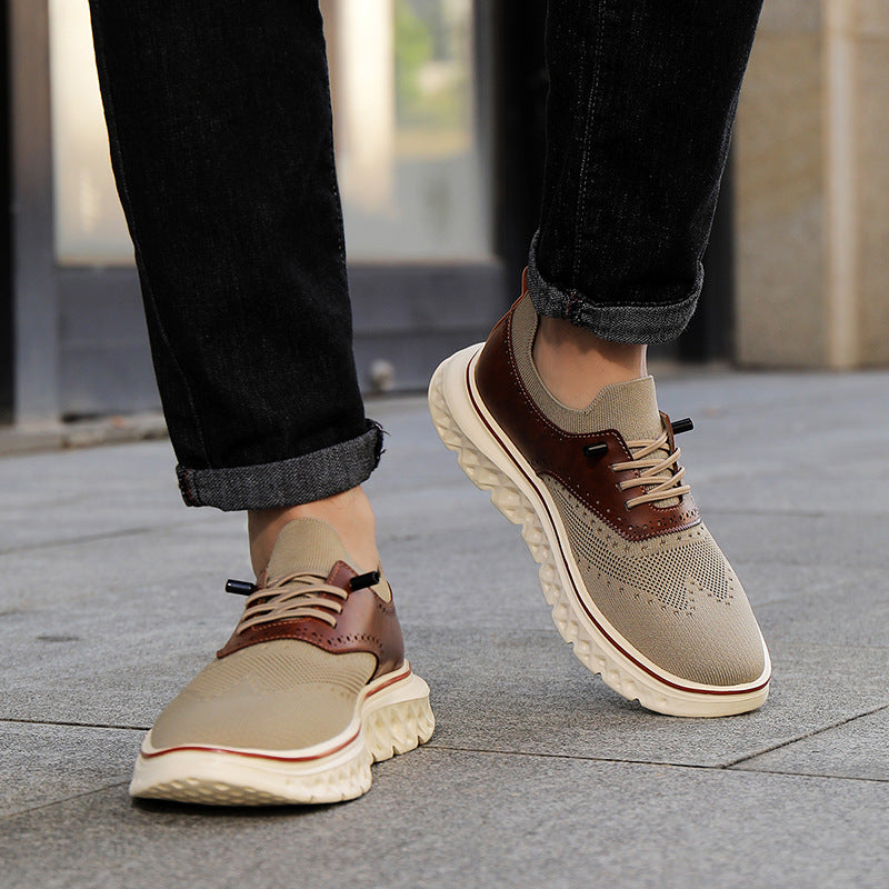 Beige and brown shoes worn with dark jeans on a pavement.