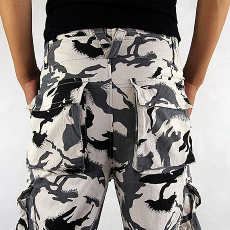 Camouflage cargo pants worn by a person on a white background