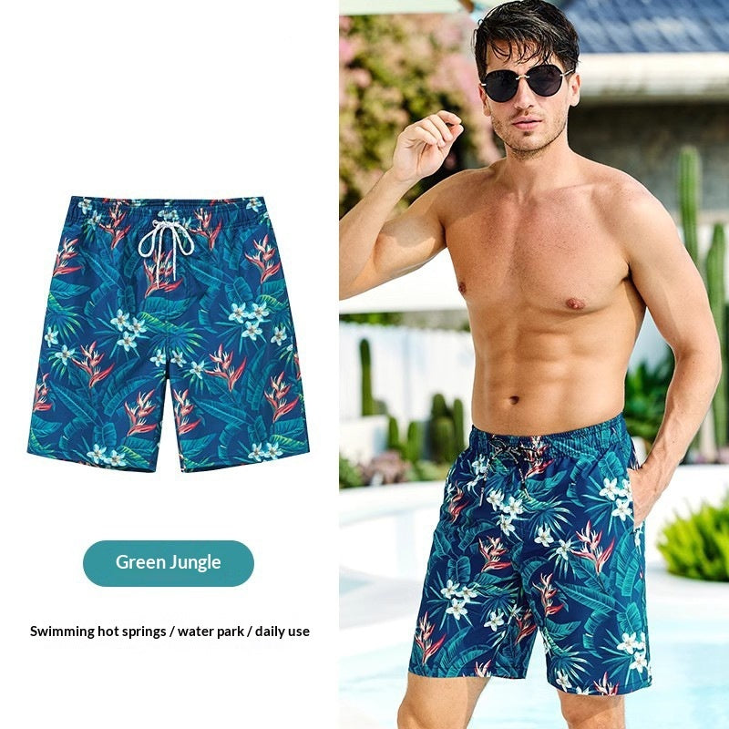 Man wearing blue floral swim shorts with a pool background