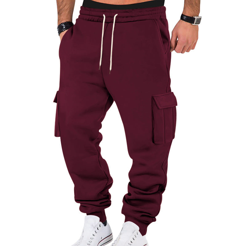 Maroon cargo jogger pants worn by a person on a white background