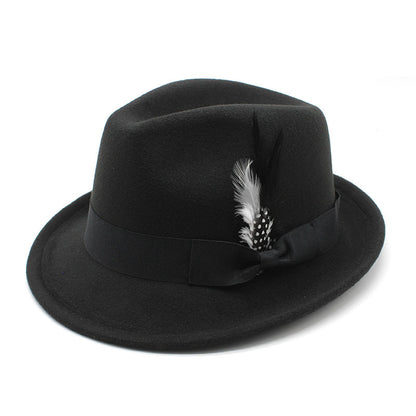 Black fedora hat with a feather on a white background