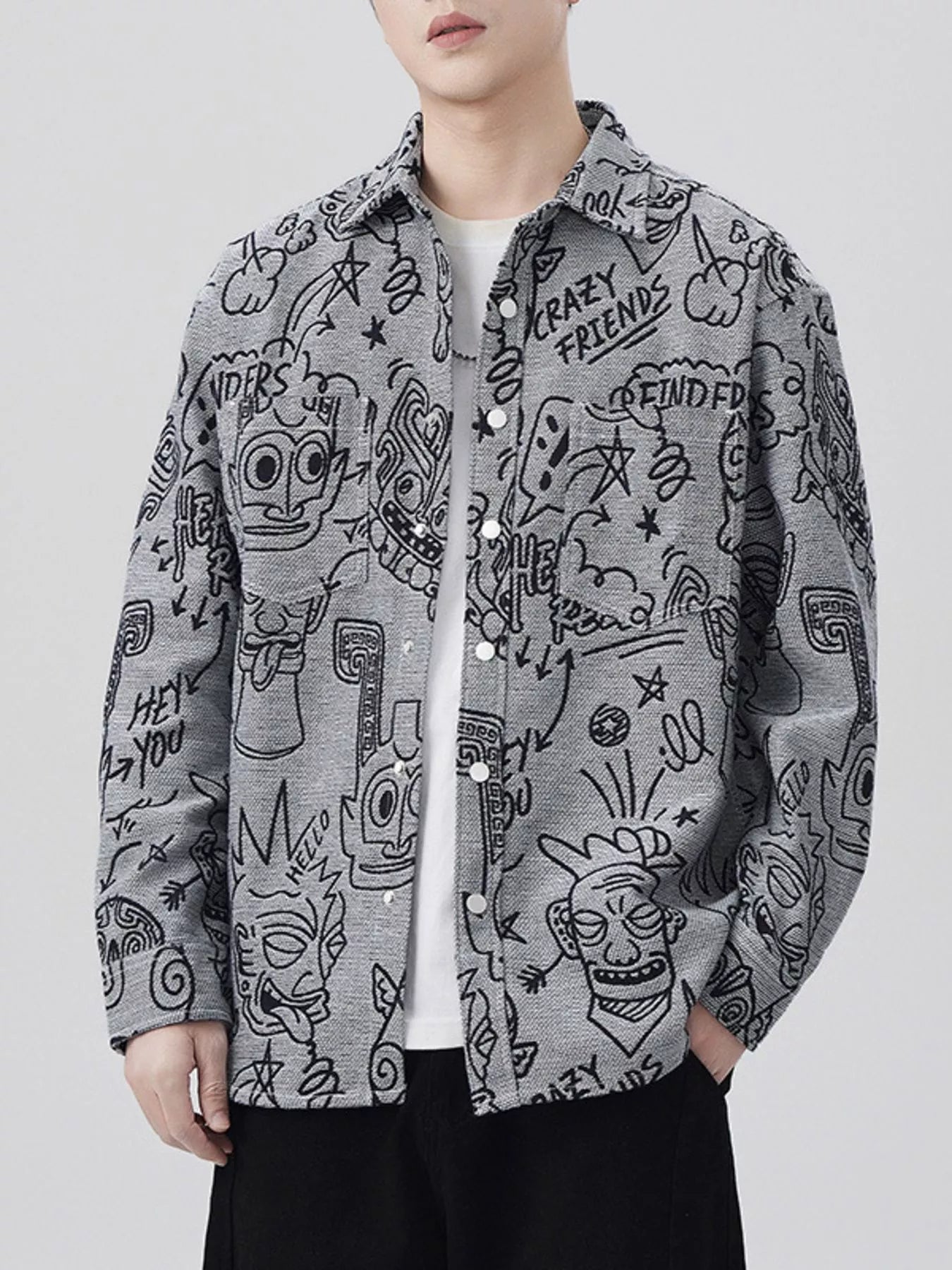Person wearing a gray jacket with black abstract designs on a white background