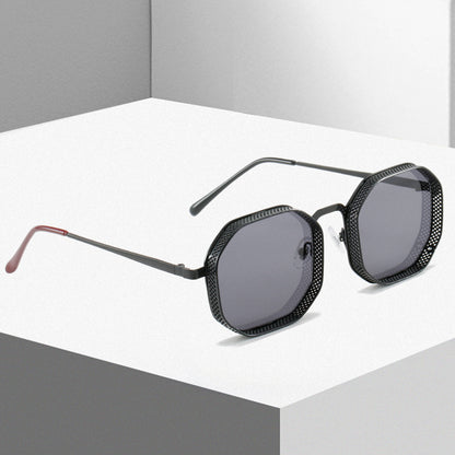 Black hexagonal sunglasses on a white platform with gray background