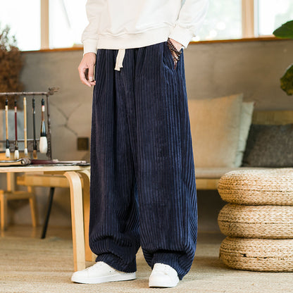 Person wearing blue corduroy pants in a living room setting