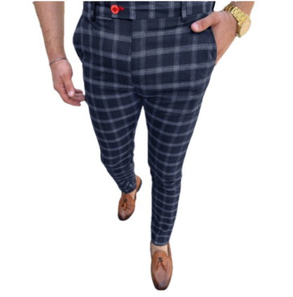 Person wearing blue plaid pants on a white background