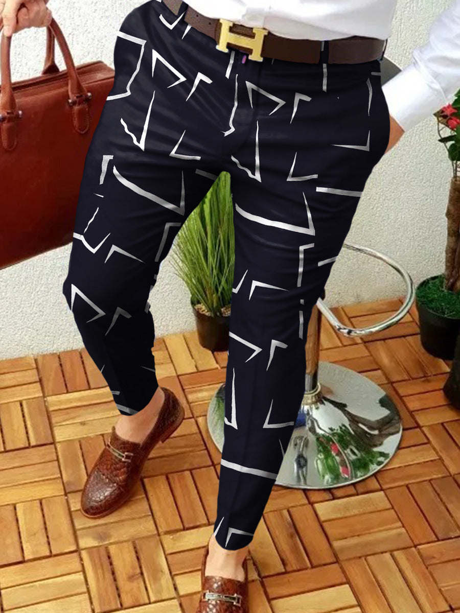 Person wearing navy pants with white geometric pattern indoors.