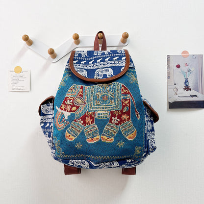 Decorative backpack with elephant design on a white wall