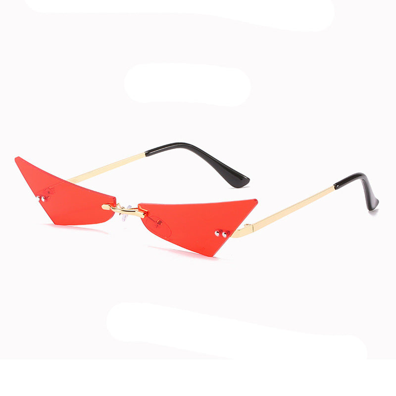 Sunglasses with red triangular lenses and black and gold frames on a white background