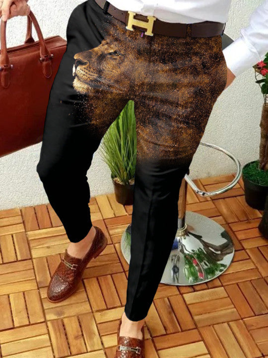 Person wearing black pants with a lion print, standing on a wooden floor.