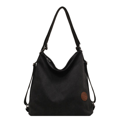 Black shoulder bag with a brown logo on a white background