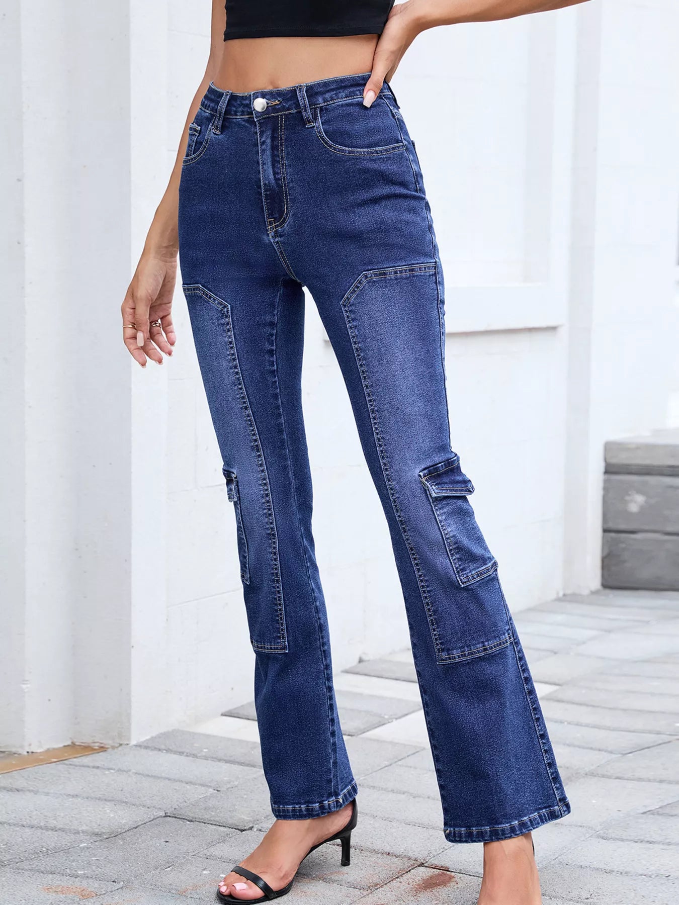 Person wearing blue jeans with a white background