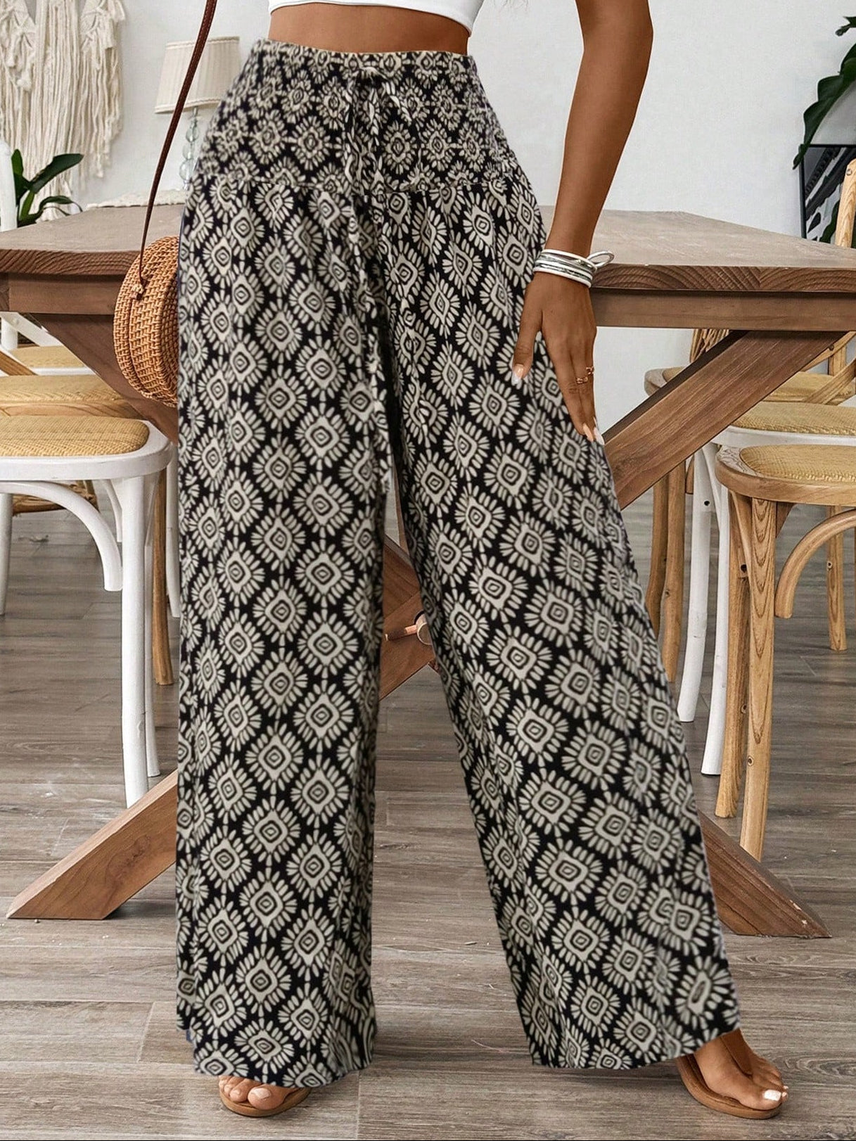Person wearing patterned wide-leg pants in a casual setting