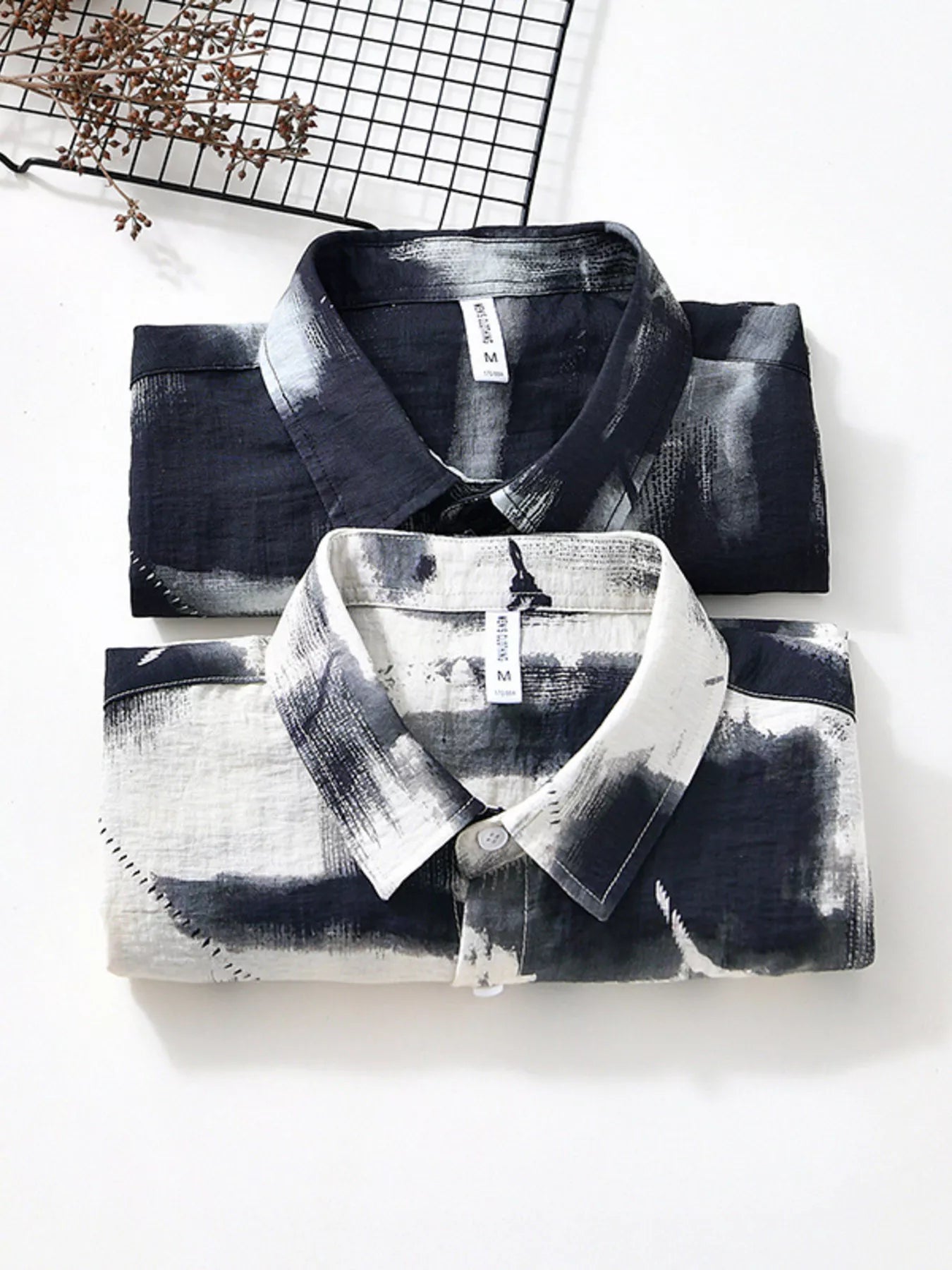 Black and white patterned shirts on a white background