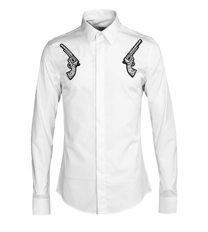 White dress shirt with black gun designs on the chest against a white background