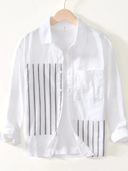 White shirt with black vertical stripes on a hanger against a white background