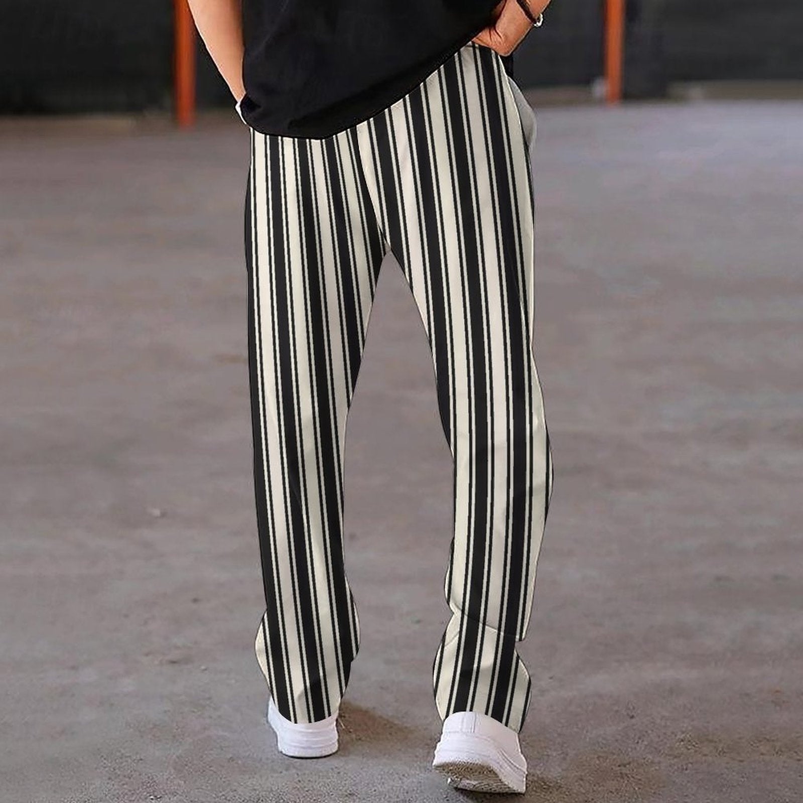 Person wearing black and white striped pants on a blurred background