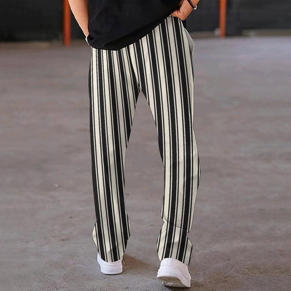 Person wearing black and white striped pants on a blurred background