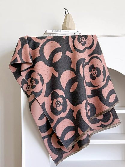 Pink and black patterned scarf on a white surface