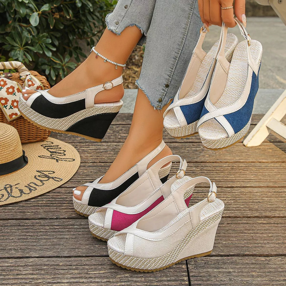 Wedges on a wooden surface with a straw hat and floral bag in the background