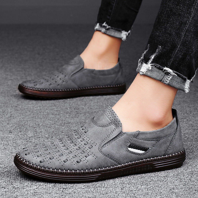 Gray casual shoes worn by a person on a gray surface