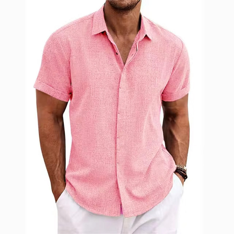Man wearing a pink short-sleeve shirt and white pants on a white background