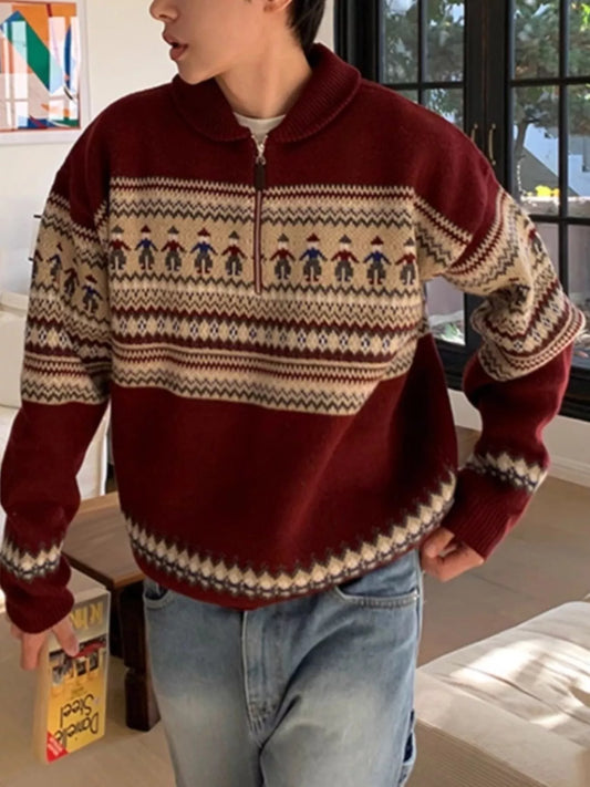 Person wearing a patterned sweater with a neutral background