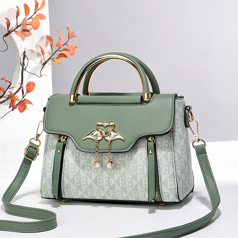 Green handbag with gold accents on a light gray background