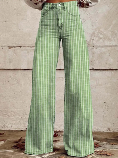 Green checkered pants worn by a person against a concrete wall.
