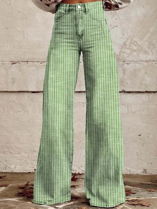 Green checkered pants worn by a person against a concrete wall.