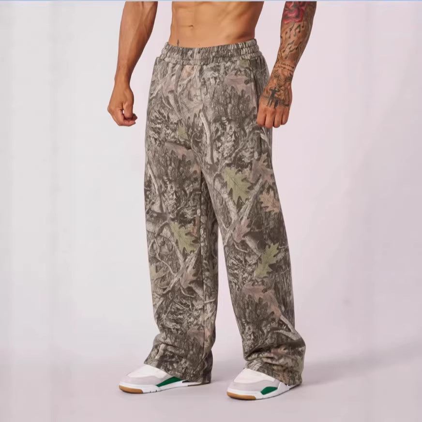 Camouflage pants worn by a person on a white background