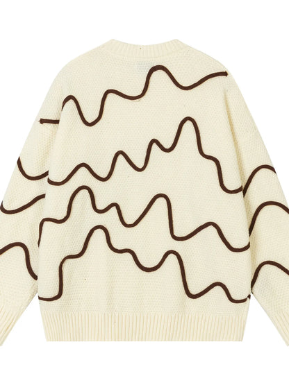 Beige sweater with brown wavy lines on a white background