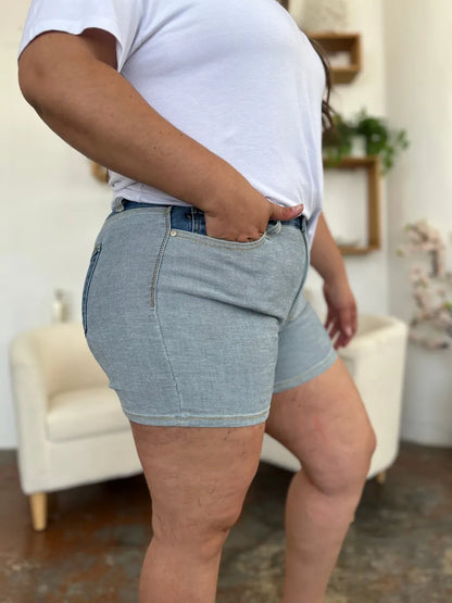 Person wearing light blue denim shorts in a casual indoor setting