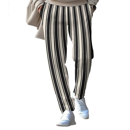 Black and white striped pants worn by a person on a white background.