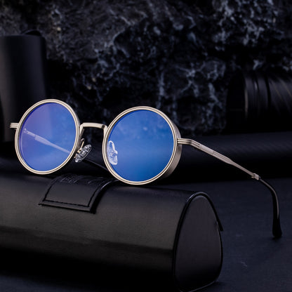 Round blue sunglasses with gold frame on a black background