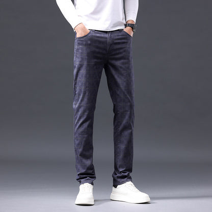 Person wearing dark gray pants and white shoes on a gray background