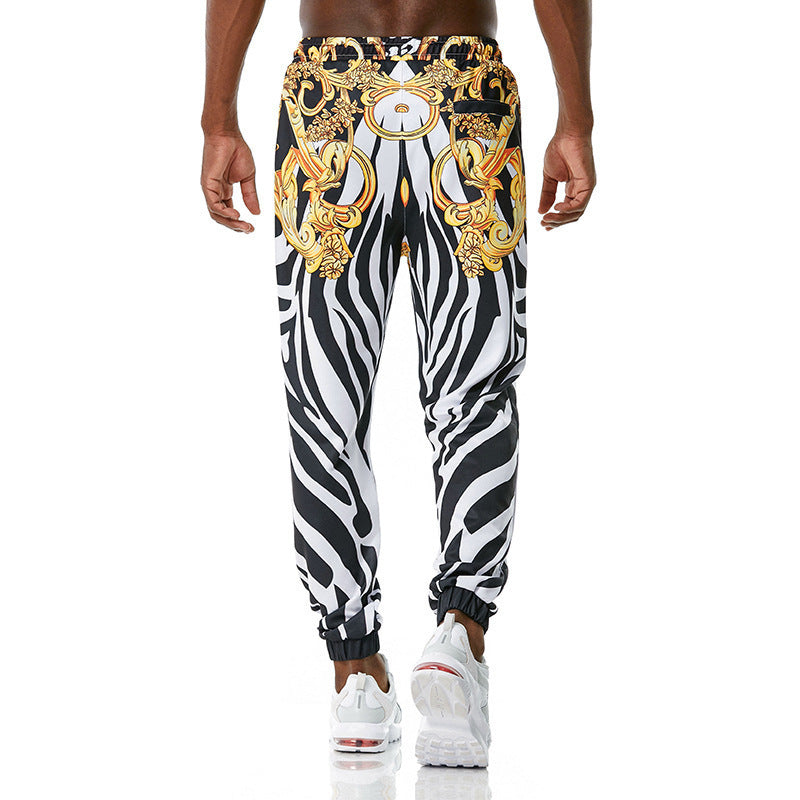 Zebra print pants with gold baroque design on a white background