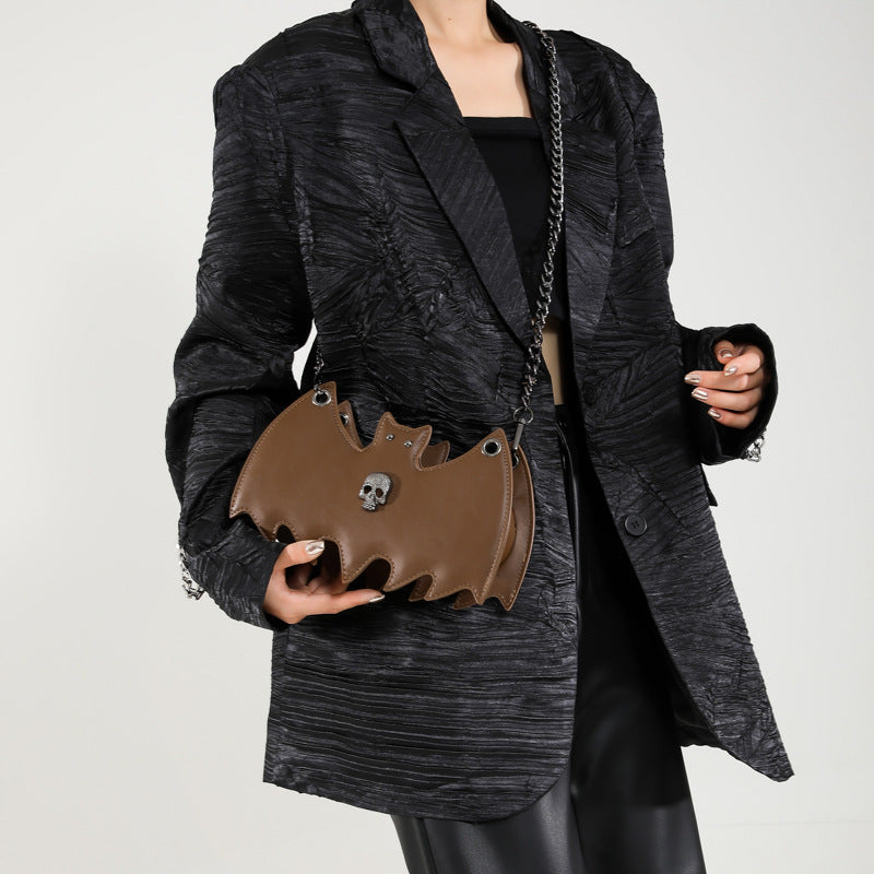 Handbag shaped as a bat on a white background.