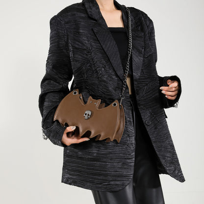 Handbag shaped as a bat on a white background.