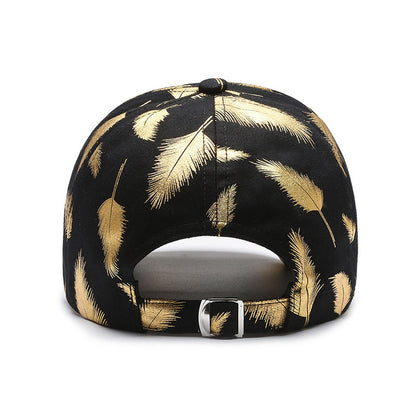 Black cap with gold feather pattern on a white background